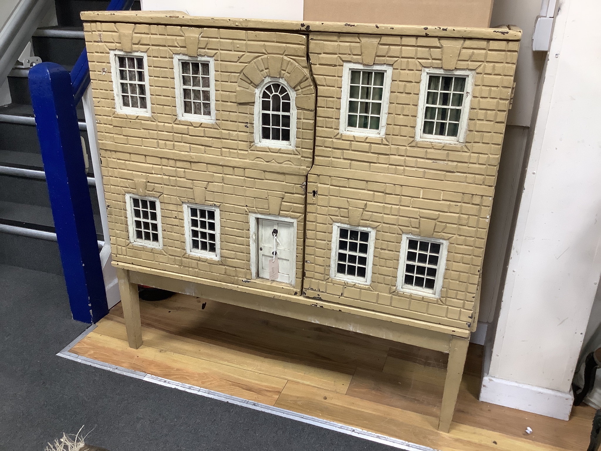 An early 19th century painted doll's house with block work facade enclosing a four room interior with central staircase, to be sold with assorted later furniture and accessories, width 117cm, depth 48cm, height with asso